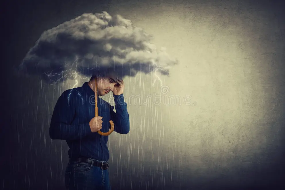 A man is standing under a rain cloud and holding his head with one hand and the other is holding up an umbrella to stop him getting wet